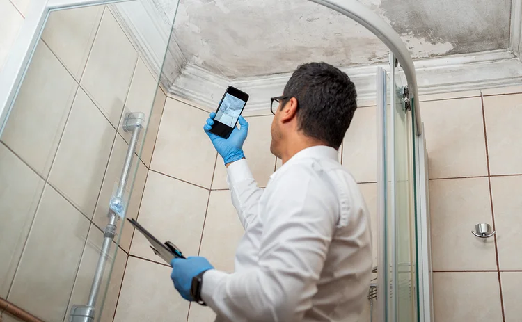 Insurance adjuster checking mould in bathroom