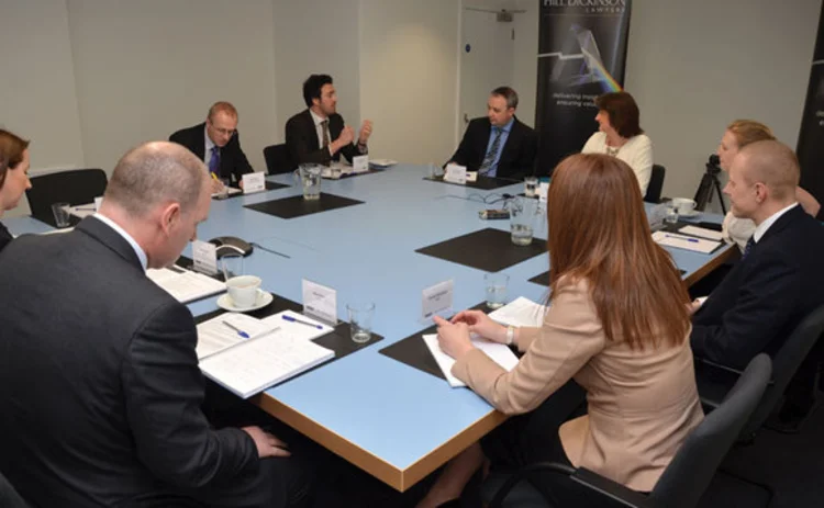 A group of people sitting round a table at the Post magazine Laspo roundtable