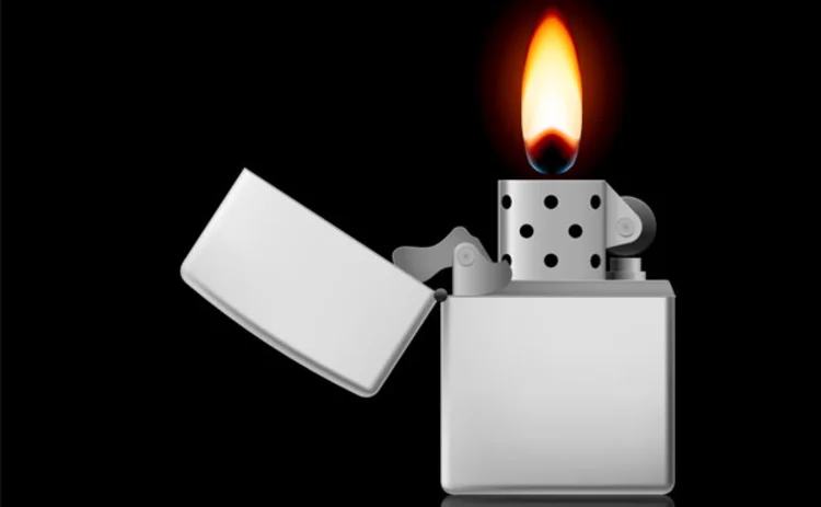 A lighter with a flame on a black background