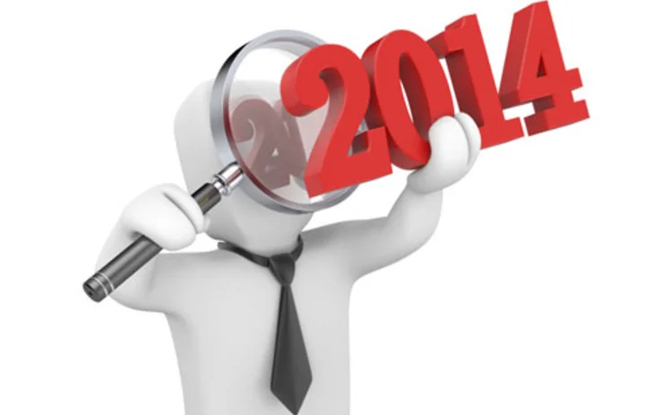 A cartoon figure looking at 2014 through a magnifying glass