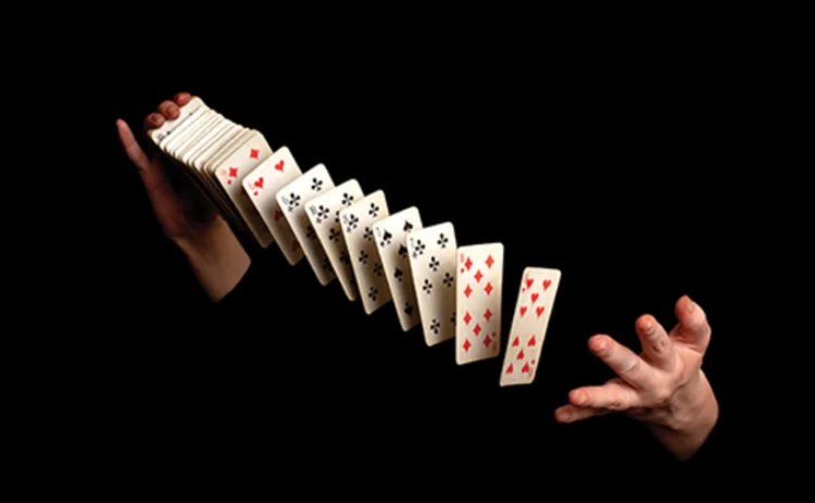 Picture of a magician shuffling a pack of playing cards