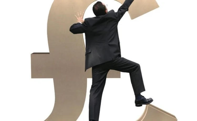 Man climbing pound sign