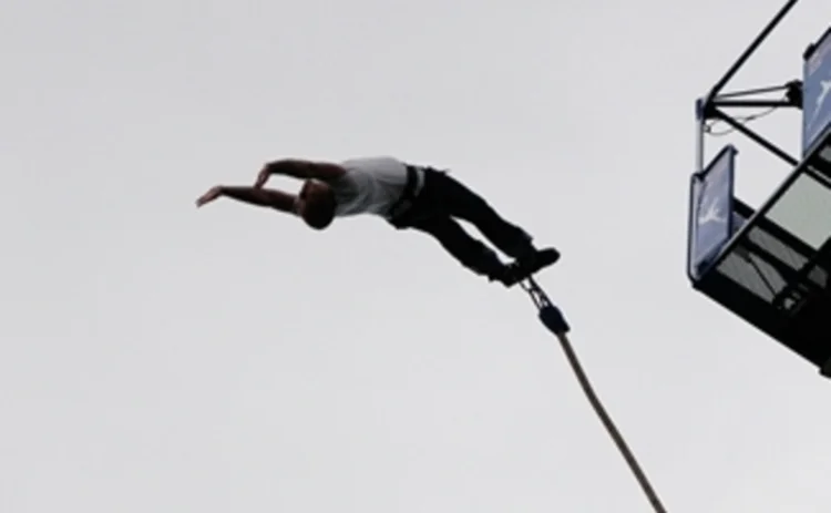 A partner mid bungee jump