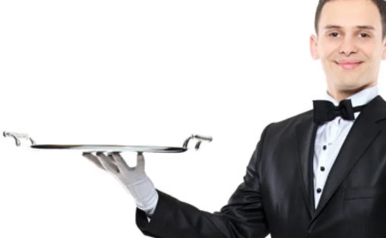 A waiter holding a serving tray