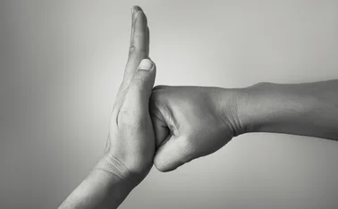 Hand preventing stopping punch attack of another hand.