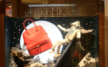 Moscow, Russia - January 9, 2021: Creative show window, store display of Hermes boutique shop in GUM department store in Moscow city (State Department Store). Neon art in show windows. Hermes fashion.