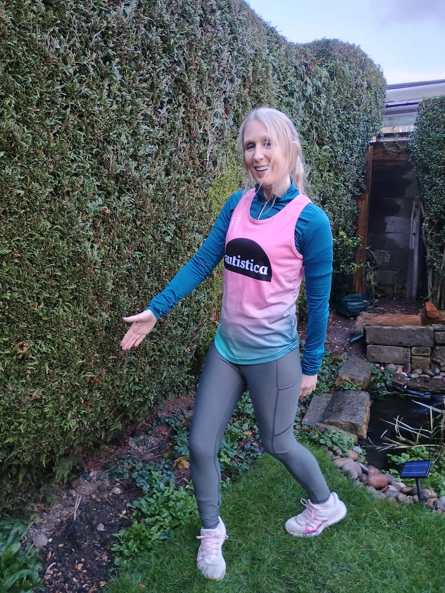 Sarah Poulter posing in her pink Autistica vest.