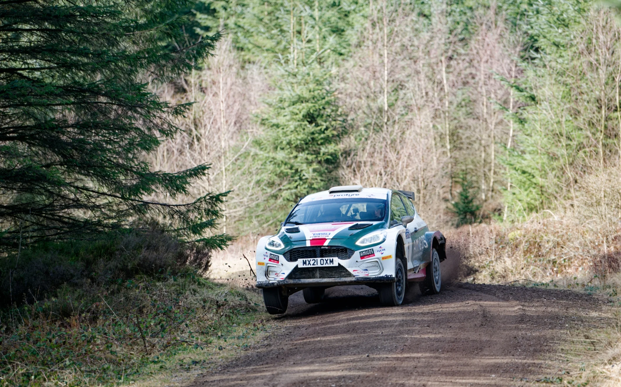 Motorsport racecar driving on a road.