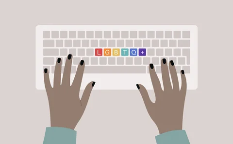 Hands typing on a keyboard, top view, rainbow buttons with an LGBTQ+ sign, queer community support