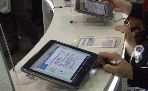 Samsung Smart School display with visitors trying mobile tablets