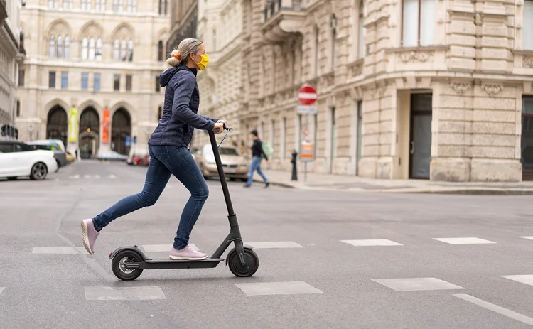 Lady riding e-scooter in Europe