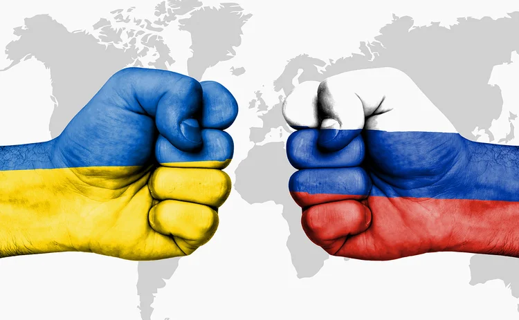 Ukraine and Russia flags in fists