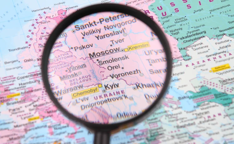 Map with magnifying glass showing Moscow and Kyiv