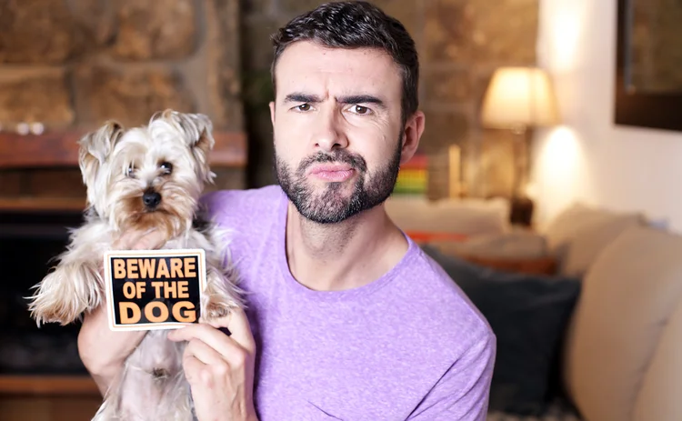 Man and new pet dog - Beware of The Dog sign