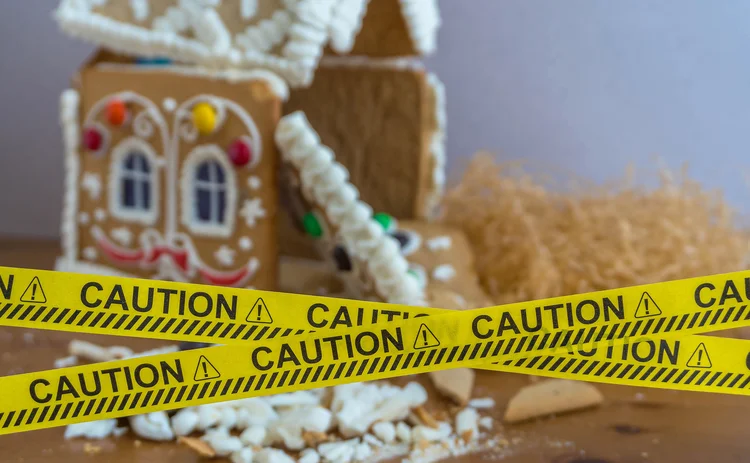 Ruined gingerbread house behind a police tape. Ruined walls, mortgage, credit, bankruptcy.