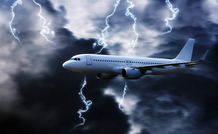 Airplane in the sky with thunder and lightning,The plane flies in terrible thunderstorm
