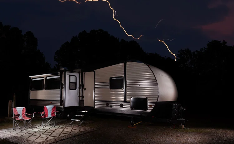 Caravan with lightning in background