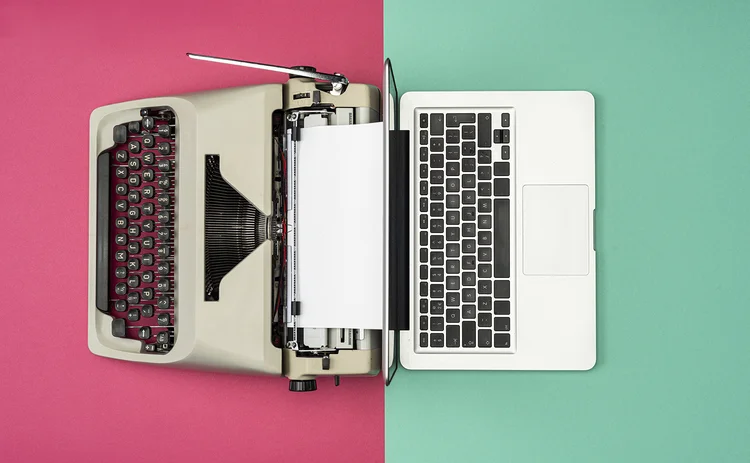 Classic analog typewriter vs Modern digital hi-tech laptop computer