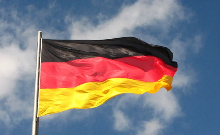 German flag flying in a blue sky