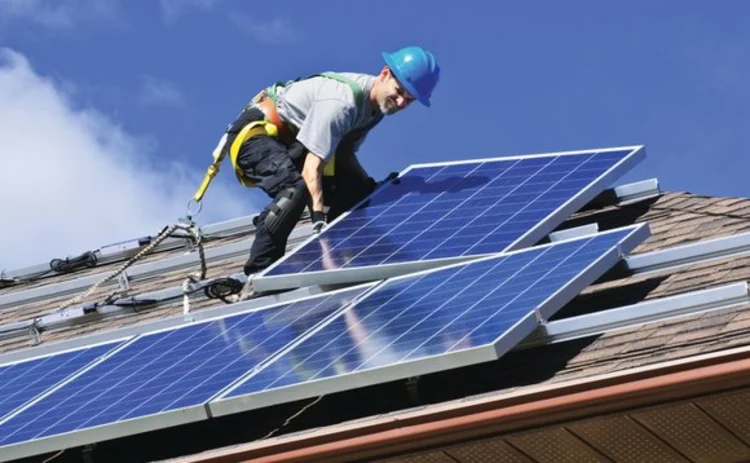 An engineer fitting solar panels