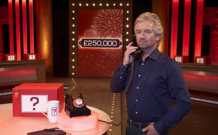 Deal No Deal presenter Noel Edmonds holding a telephone