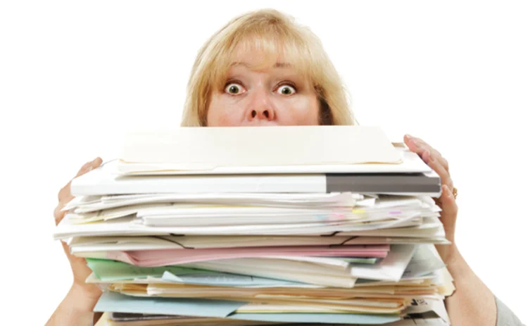 A woman buried by paper work