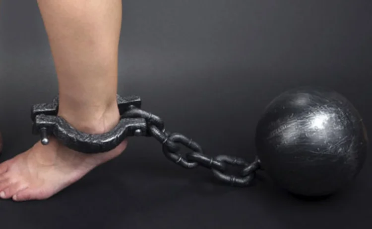 A ball and chain shackling an ankle