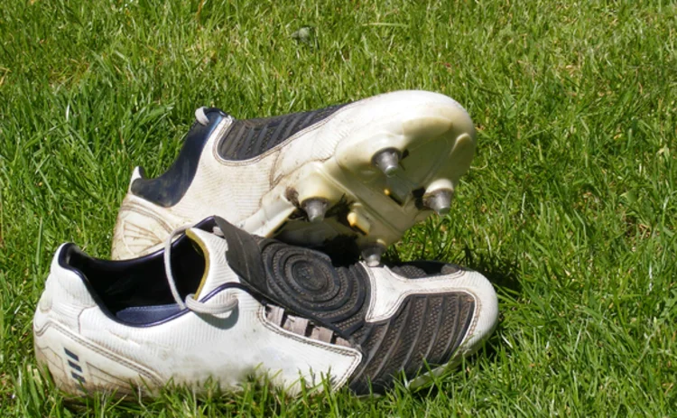 Football boots left on grass