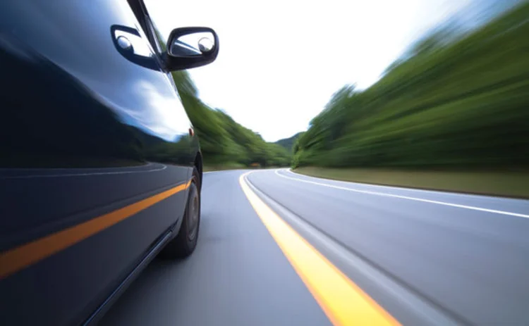 Close up of a car travelling fast on a road