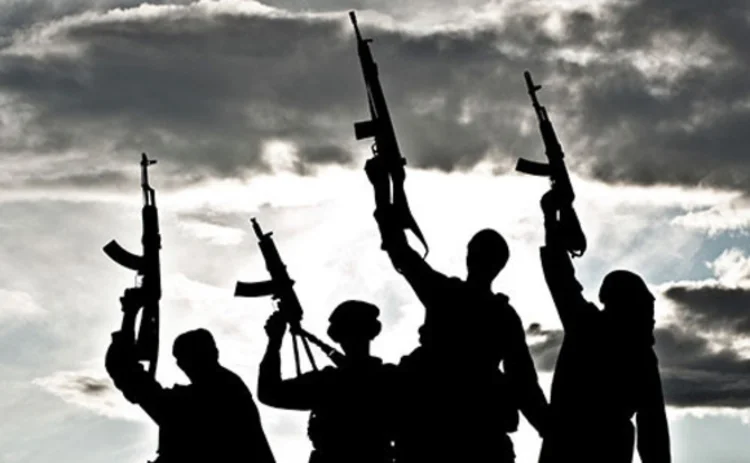 Silhouette of militia terrorists waving guns in the air