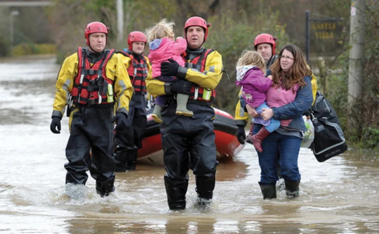  A family are rescued from their home in Gloucester during flooding on 27 November
