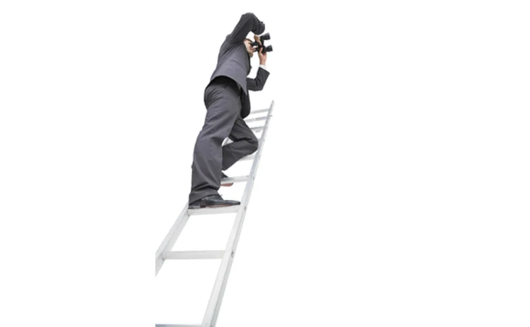 Man on ladder with binoculars