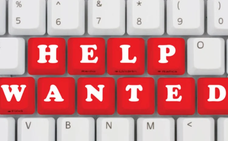 The words 'help wanted' spelled out on a keyboard