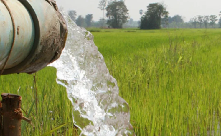 Water pipe spilling onto a green field