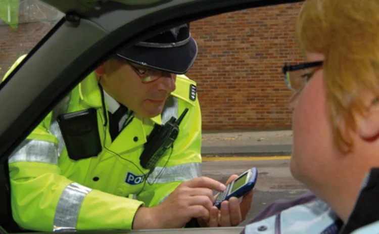 A police officer speaking to a driver