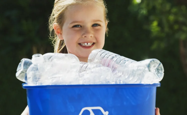 Environmental child holding recycle bin