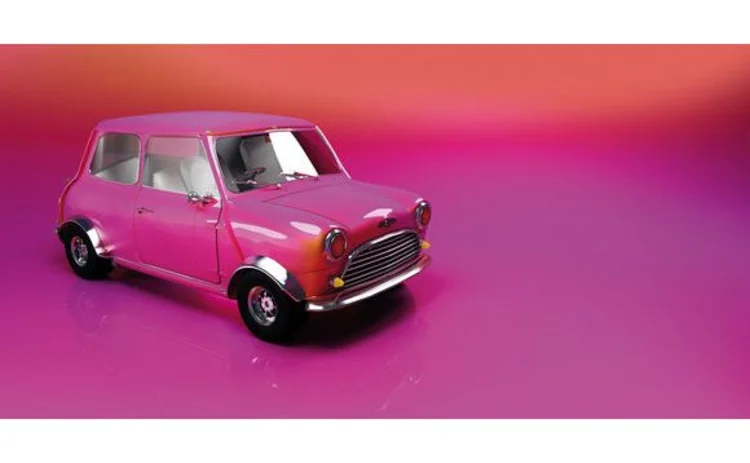 glossy-pink-mini-car-on-pink-background-copy-space