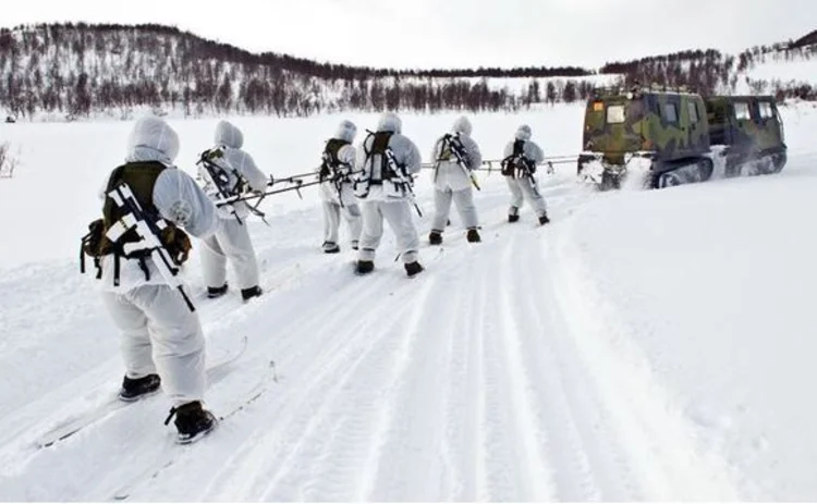 Arctic marines ski-jorring behind a BV