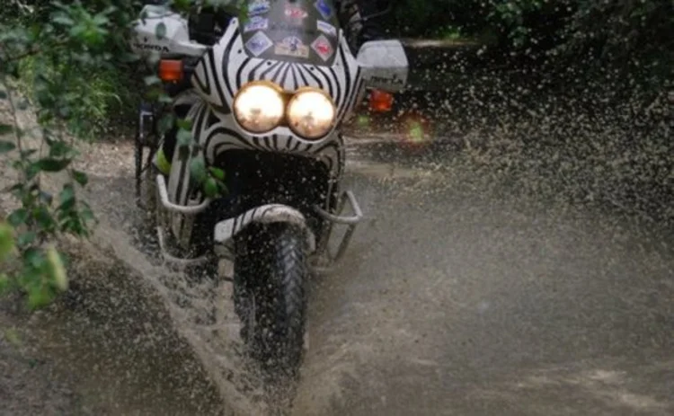 motorbiker rides through puddle