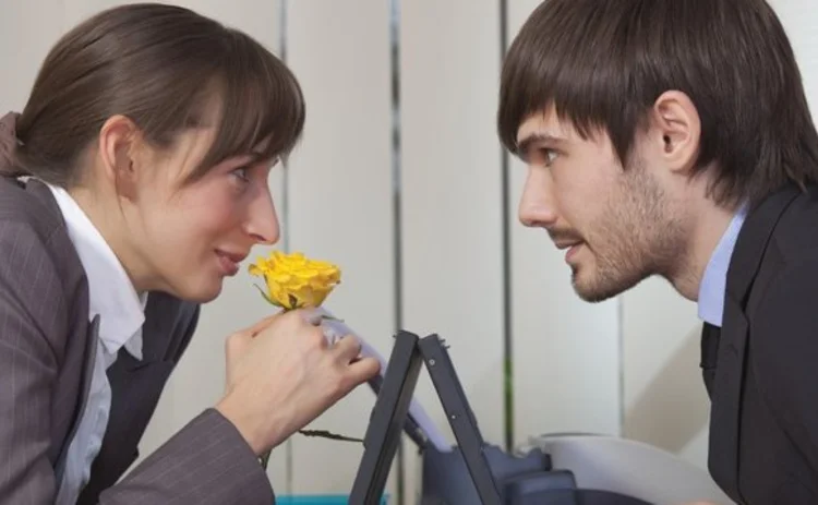 Man and woman exchanging a flower