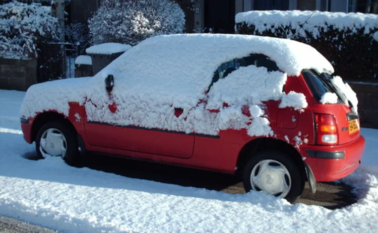 Red car covered in snow