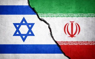 Israel and Iran flags against a cracked background