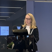 Lucy Rigby KC MP standing at a podium.