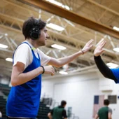 Neurodivergent man high fives his coach 